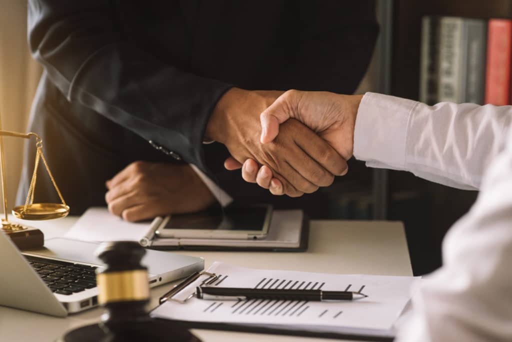 Bankruptcy lawyer shakes hands with client